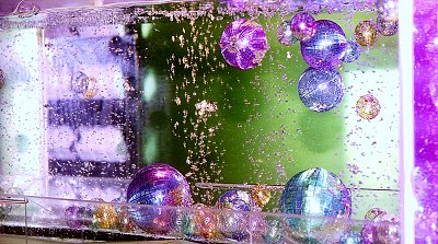 Titanium Colored Mesh Ball swims around , by itself